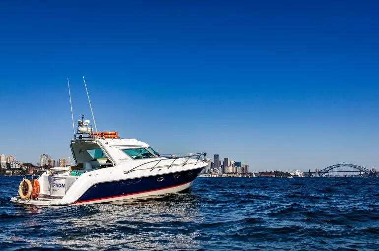 Inception sports cruiser navigating through clear blue waters with skyline backdrop.