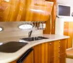 Sleek interior kitchen area of an Inception sports cruiser yacht.
