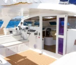 Helm station and cockpit seating of the Wanderlust motoryacht by Dreamboats with view into interior saloon.