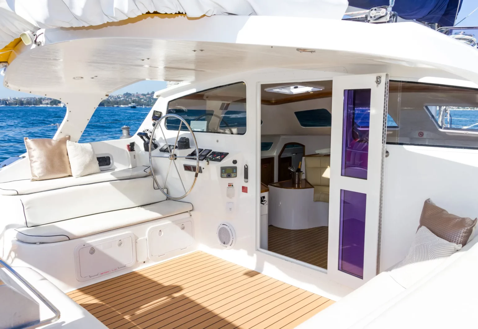 Helm station and cockpit seating of the Wanderlust motoryacht by Dreamboats with view into interior saloon.