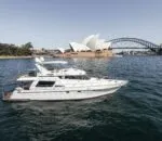 Enigma boat in Sydney Harbour with the Opera House and bridge.