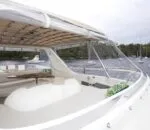 Enigma boat in Sydney with spacious deck and scenic water view. Variation #1: Enigma boat in Sydney featuring a sleek design and open deck area.