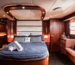 Luxurious interior of the enigma boat in Sydney featuring a cozy bedroom.