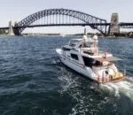 Enigma boat cruising on Sydney Harbour beneath the iconic bridge.