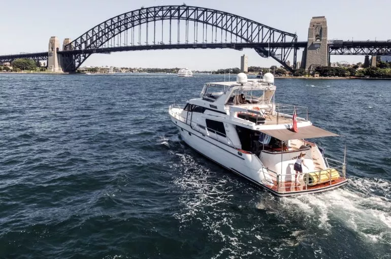 Enigma boat cruising on Sydney Harbour beneath the iconic bridge.