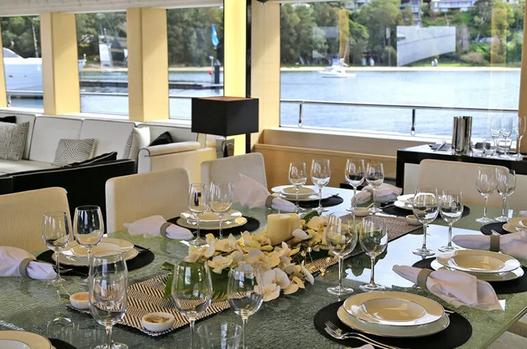 Elegant dining setup on the Ghost II Superyacht with scenic views.