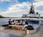 Relaxing guests enjoying drinks on the deck of Ghost II Superyacht.
