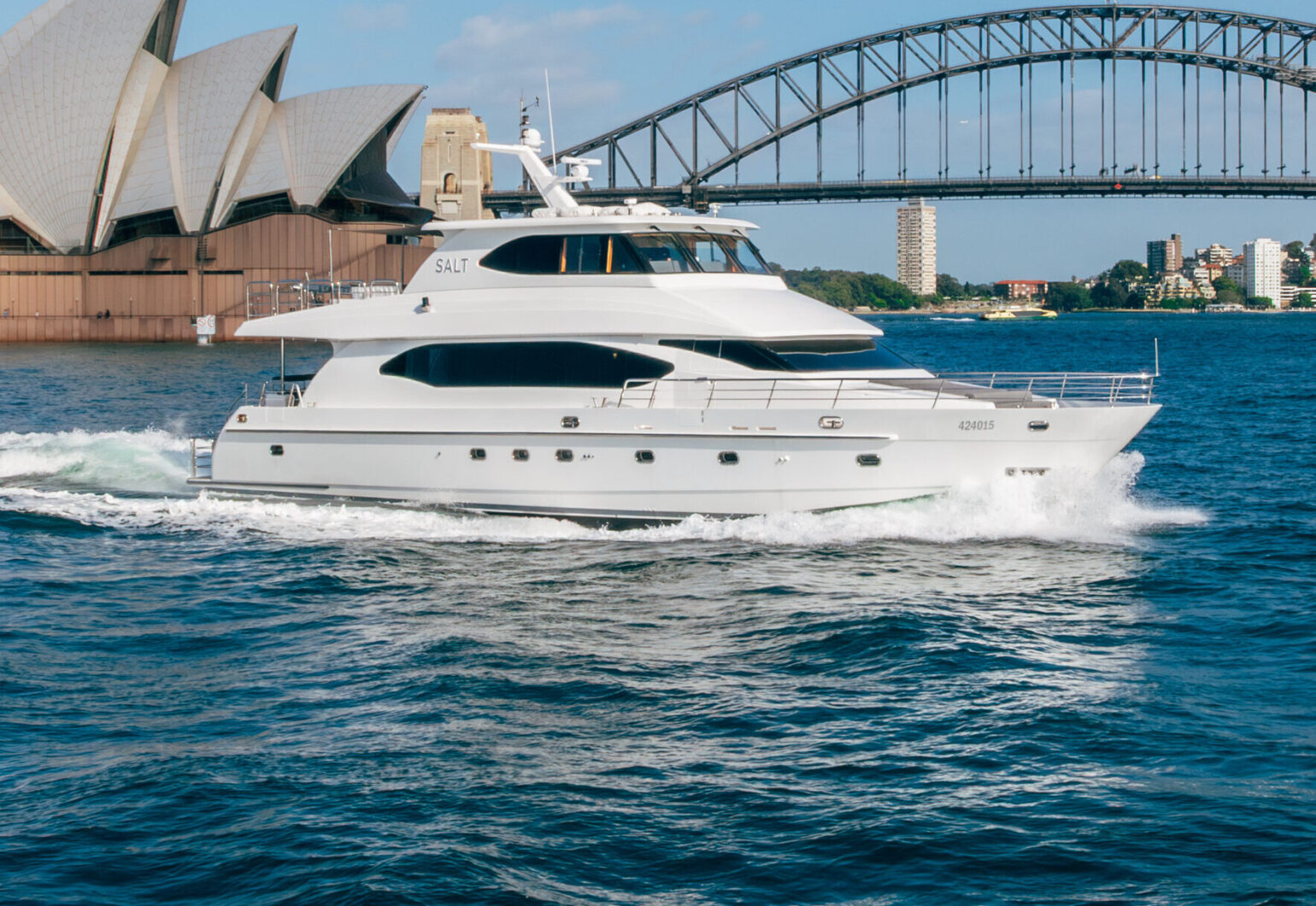 Luxury salt boat cruising near Sydney's iconic Opera House and Harbour Bridge.