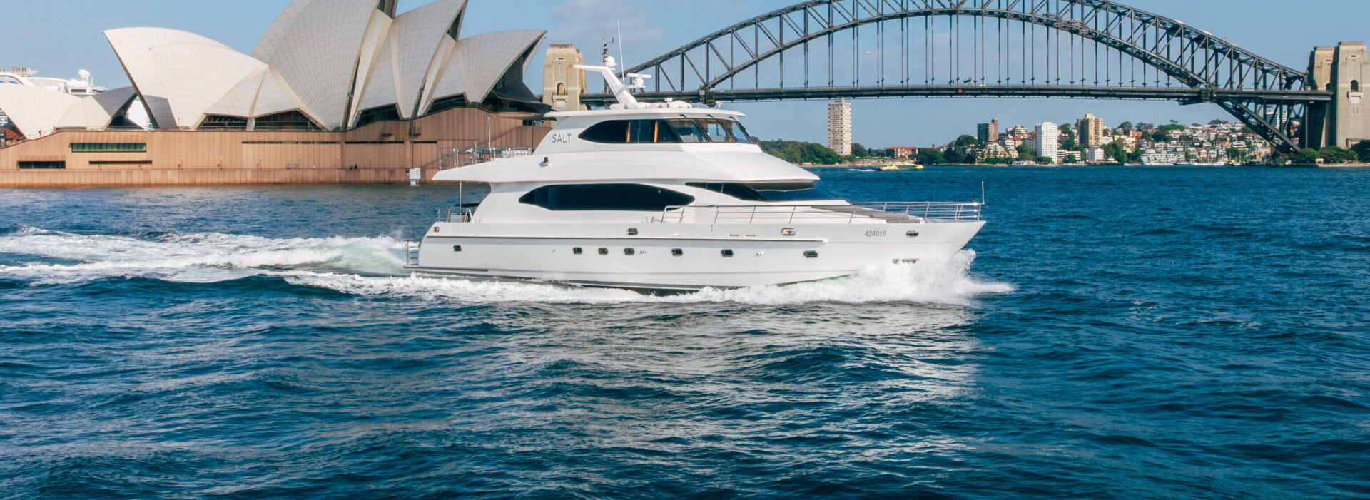 Luxury salt boat cruising near Sydney's iconic Opera House and Harbour Bridge.
