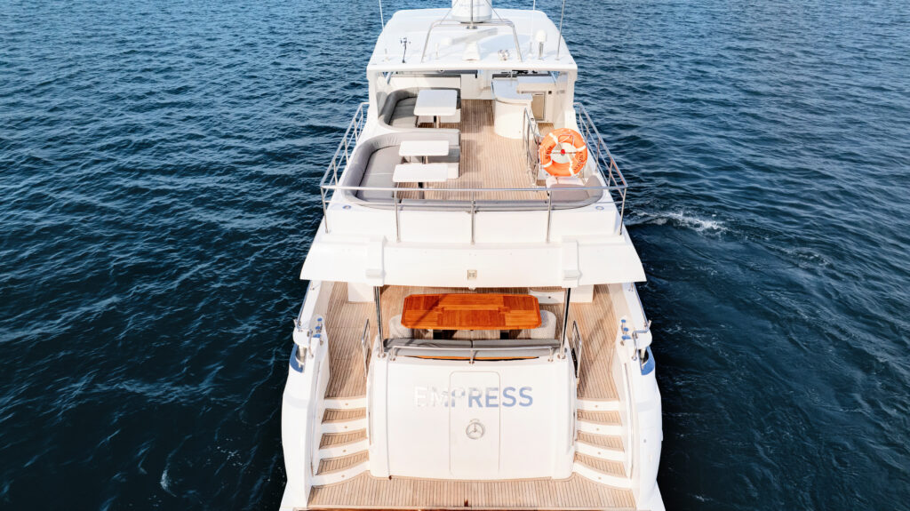 Luxurious Empress Motoryacht with spacious deck and seating area. Stylish Empress Motoryacht featuring a comfortable outdoor lounge space.
