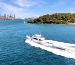 Empress 77ft motoryacht cruising across open water by Dreamboats