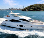 Luxury Empress Motoryacht cruising through blue waters near a city skyline. Variation #1: Empress Motoryacht navigating vibrant waters with a scenic city backdrop.