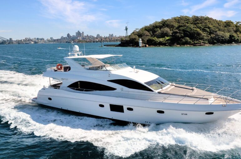Luxury Empress Motoryacht cruising through blue waters near a city skyline. Variation #1: Empress Motoryacht navigating vibrant waters with a scenic city backdrop.