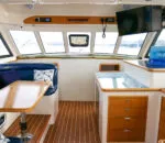 Interior view of Life’s Good catamaran featuring seating and a kitchen area.