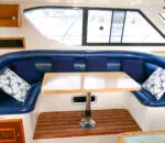 Cozy seating area with a table inside Life’s Good catamaran.