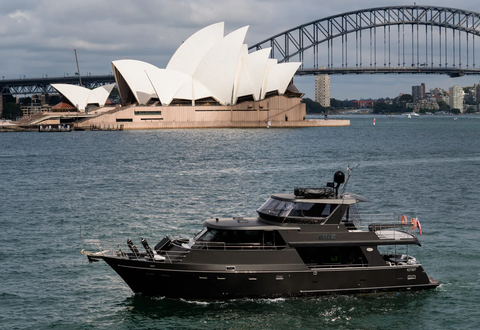 Antares boat cruising near Sydney Opera House and Harbour Bridge.