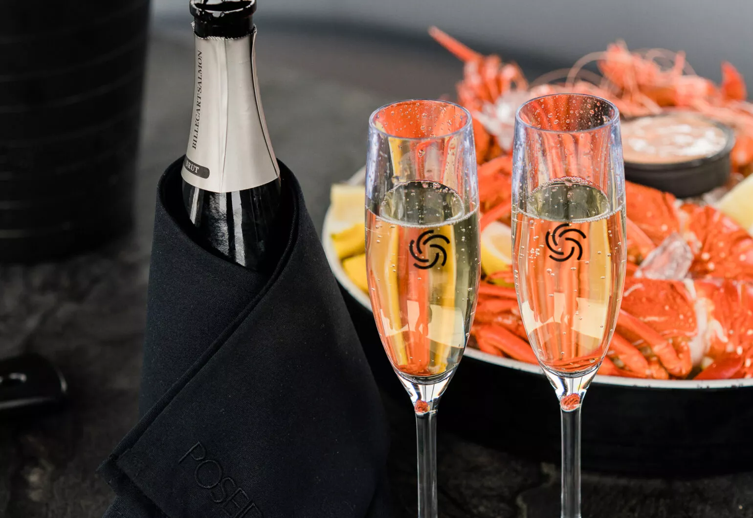 Champagne flutes and seafood platter on Antares boat in Sydney.