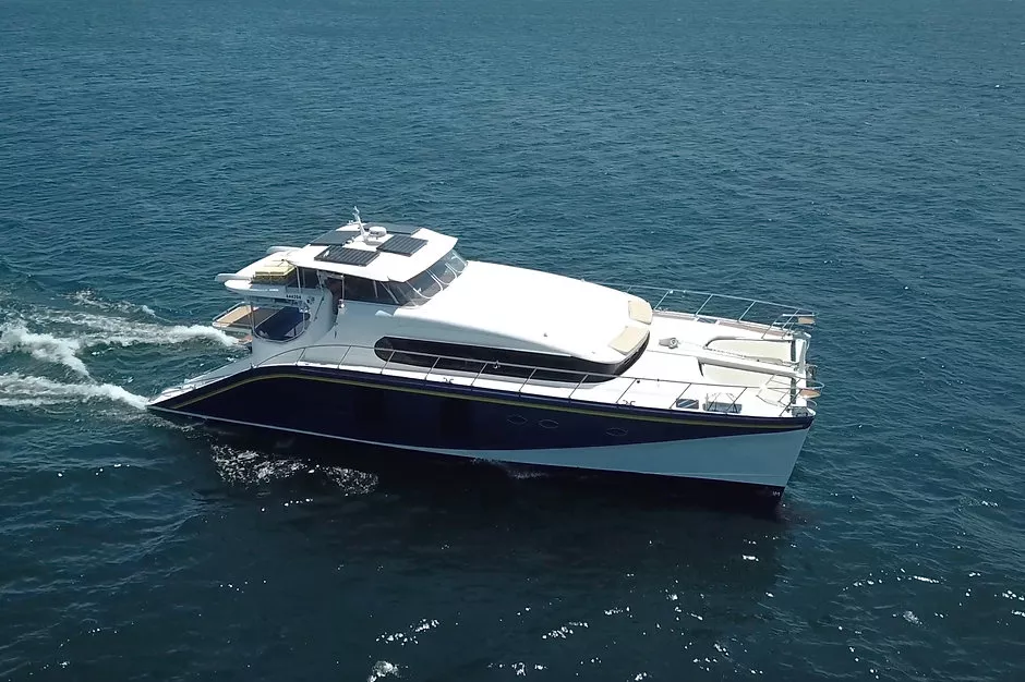 Sleek Passion Catamaran gliding smoothly over clear blue waters.
