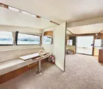 Spacious interior of a Passion Catamaran with large windows and seating area.