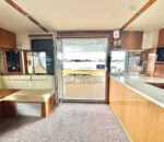 Spacious interior of a Passion Catamaran featuring a dining area and kitchen.