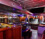 Interior of a catamaran with colorful lights and seating, showcasing ocean life catamaran charter Sydney.